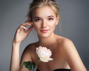 Beautiful, blonde woman with a white rose.