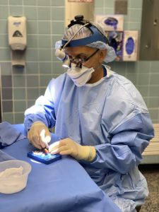 plastic surgeon preparing for a surgery