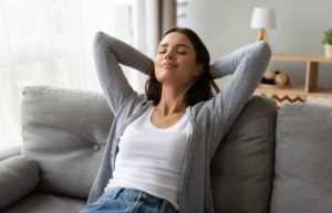 woman relaxes at home and breathes free
